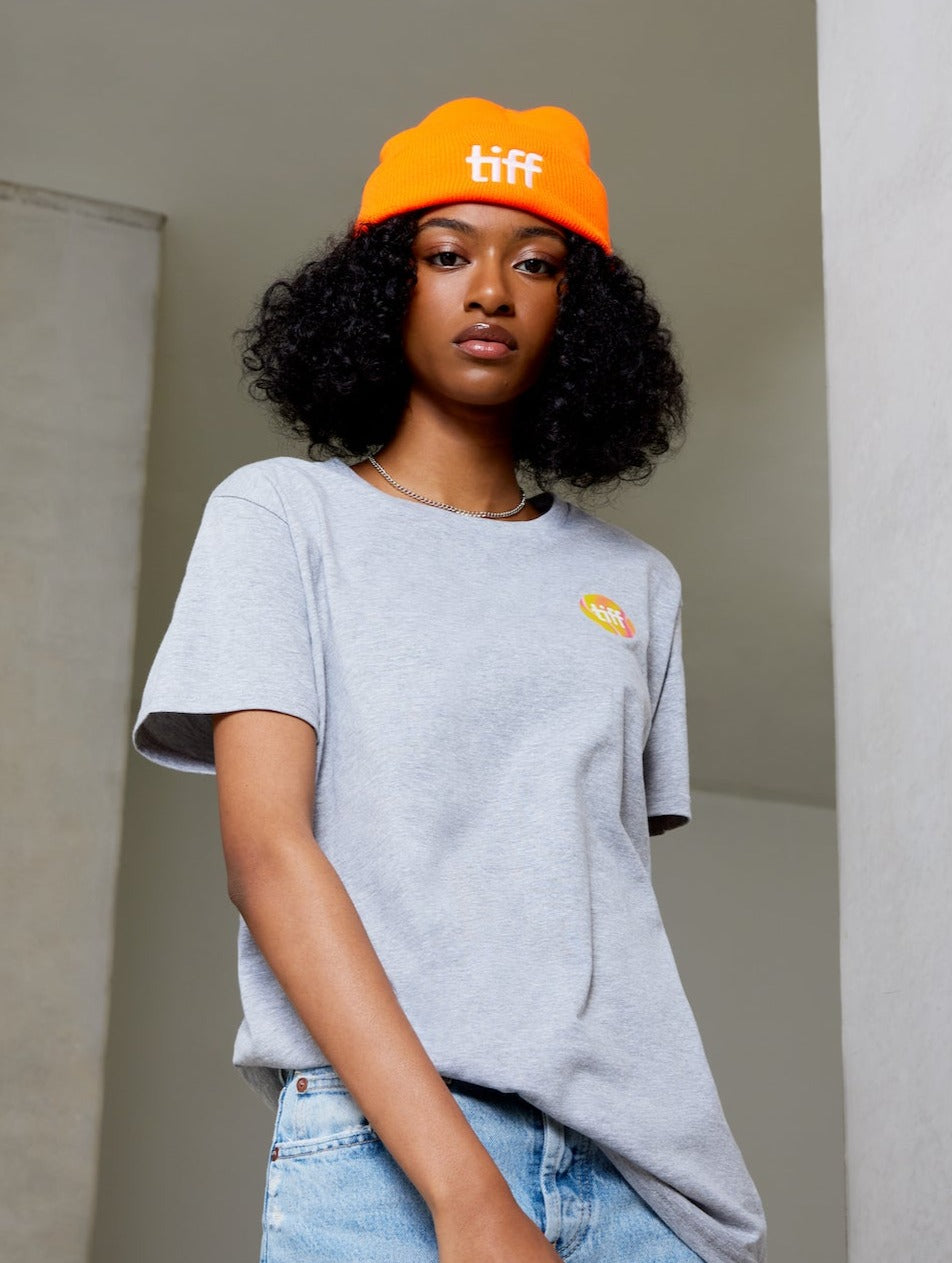 Woman in grey TIFF t-shirt and orange toque