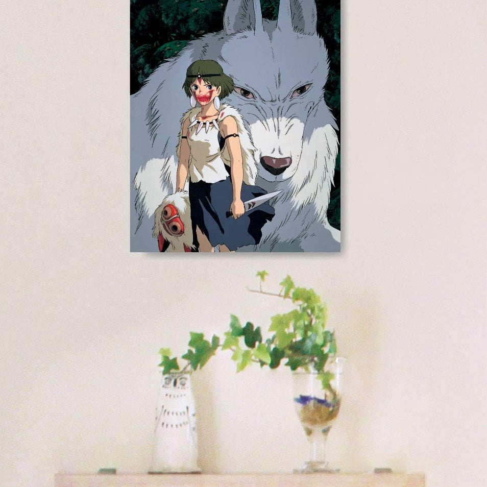 A framed art print puzzle of Princess Mononoke standing with Moro the wolf god hangs on a wall above a small wooden floating shelf.


