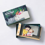 A flat lay display of a "My Neighbor Totoro" stationery set featuring illustrated notecards and tan envelopes.