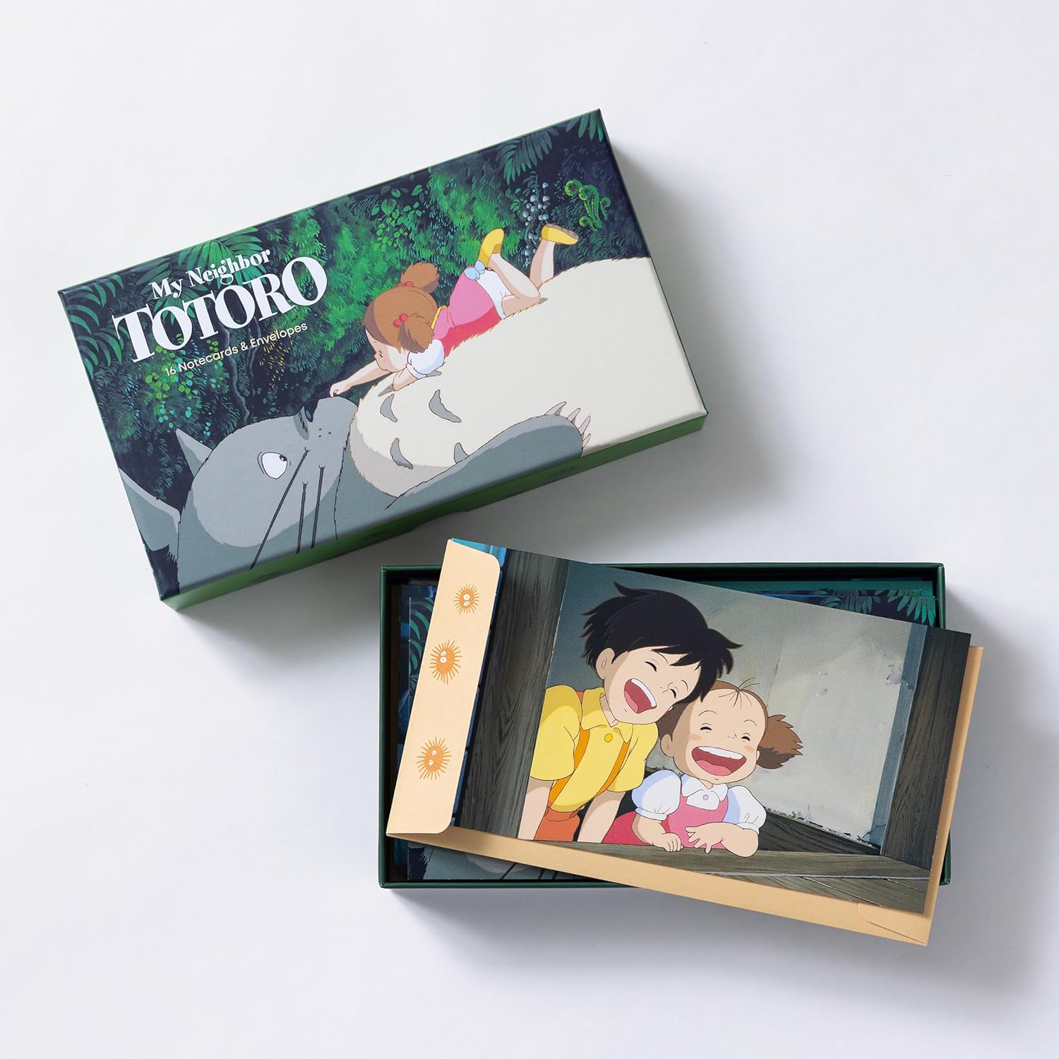 A flat lay display of a "My Neighbor Totoro" stationery set featuring illustrated notecards and tan envelopes.