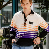 A young man wearing a vintage-style striped rugby shirt with 'tiff' printed on the chest, standing outdoors next to a bicycle.