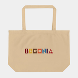 Beige coloured rectangular tote bag with top handle and printed 'Bugonia' text in multicolour at front on a white background.