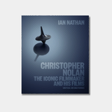 Book cover for "Christopher Nolan: The Iconic Filmmaker and His Work" featuring a spinning top from the movie Inception centered against a background of concentric blue circles.