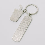 Silver-tone keychain on a white background featuring back of two "TIFF" embossed charms.