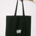 Black tote bag with 'tiff' logo held by a hand on a white background