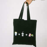 Black tote bag with colorful symbols held by a person on a white background