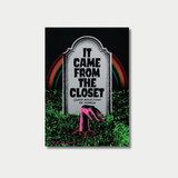 An illustrated book cover featuring a grey tombstone with the title "IT CAME FROM THE CLOSET: QUEER REFLECTIONS ON HORROR" inscribed on it, set against a dark background with a colorful rainbow arch and a pink zombie hand emerging from the green grass below.
