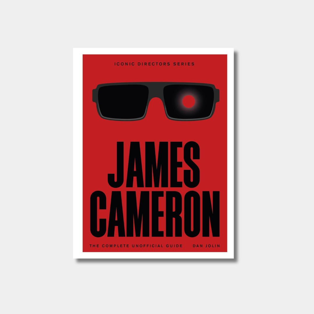 An illustrated book cover for "James Cameron: The Complete Unofficial Guide" featuring a minimalist design of black sunglasses with one red glowing lens on a solid red background.