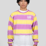 A model wears a long-sleeved cropped shirt featuring yellow, purple, and white stripes with the "TIFF" logo printed on the chest.