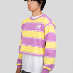 A model wears a long-sleeved cropped shirt featuring yellow, purple, and white stripes with the "TIFF" logo printed on the chest.