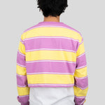 Back of model wearing a long-sleeved cropped shirt featuring yellow, purple, and white stripes.