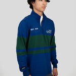 A model wears a blue and dark green quarter-zip pullover featuring "EST. 1976" and "TORONTO INTERNATIONAL FILM FESTIVAL" printed on the chest.