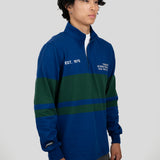 A model wears a blue and dark green quarter-zip pullover featuring "EST. 1976" and "TORONTO INTERNATIONAL FILM FESTIVAL" printed on the chest.