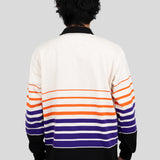 Back of model wearing a long-sleeved, collared rugby shirt featuring orange, purple, and black stripes.