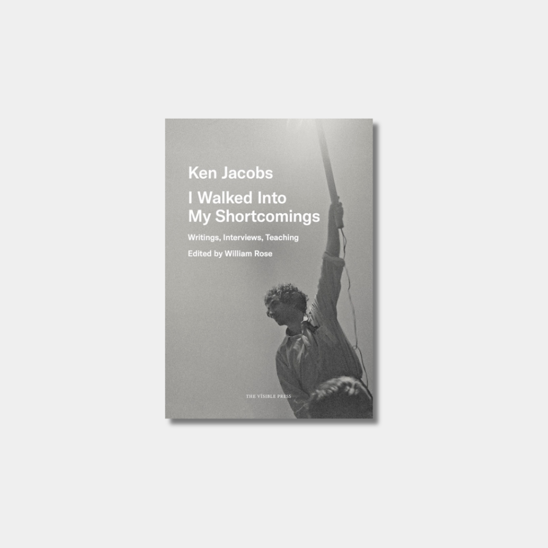 A book cover for "I Walked Into My Shortcomings: Writings, Interviews, Teaching" featuring a grainy black-and-white photograph of a man holding a long pole against a pale grey background.