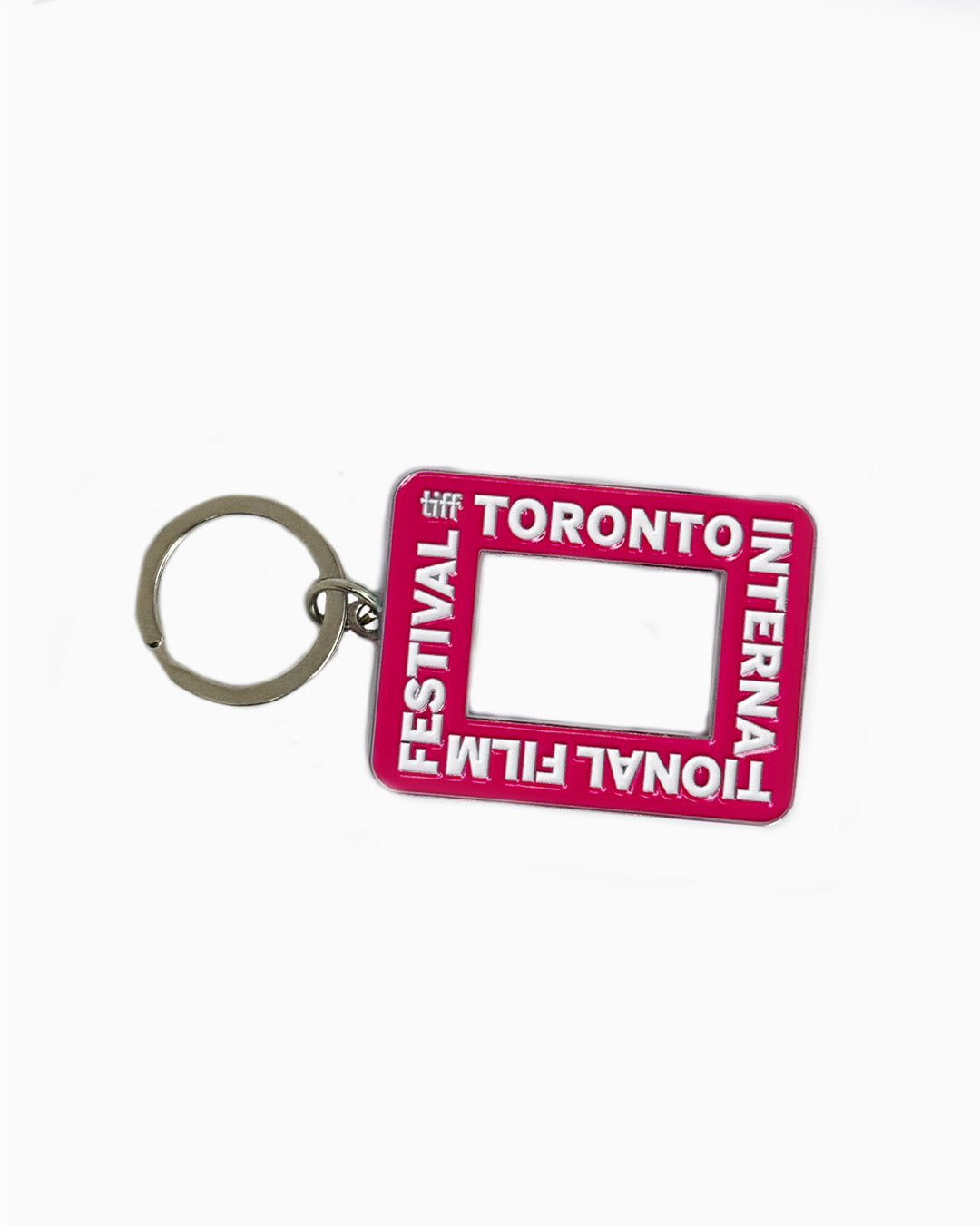 A pink rectangular enamel keychain featuring the Toronto International Film Festival logo and a cutout center resembling a camera viewfinder.