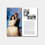 An open book spread displays a large color photograph of David Bowie and Jennifer Connelly in costume for the ballroom scene of "Labyrinth," accompanied by descriptive text and smaller black-and-white production photos.