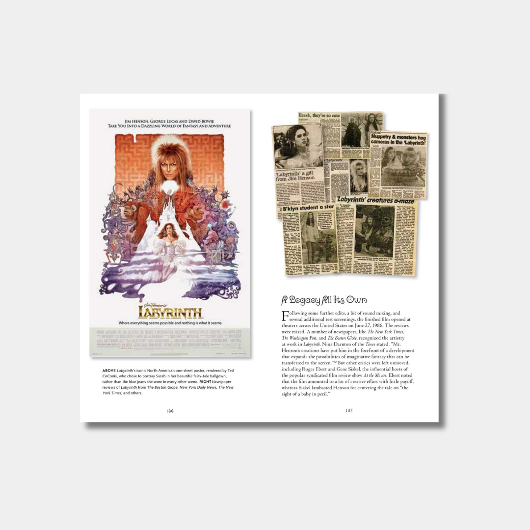 An open book spread shows the iconic "Labyrinth" movie poster on the left page and a collection of vintage newspaper clippings and reviews on the right page under the heading "A Legacy All Its Own."