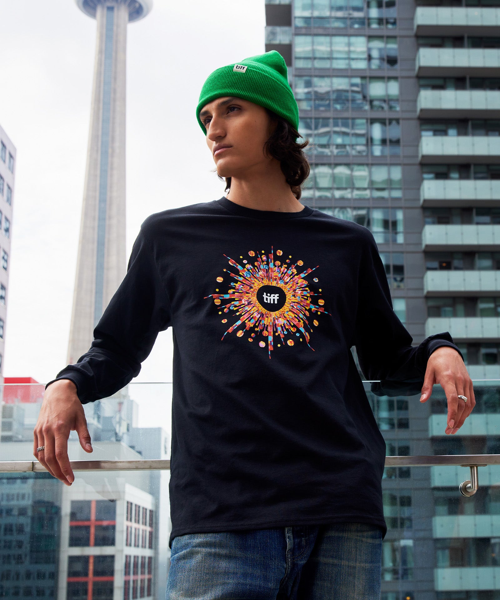 Man in TIFF 2023 festival long sleeve shirt and green toque