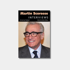 Book cover for "Martin Scorsese: Interviews, Revised and Updated" featuring a close-up photograph of a smiling Martin Scorsese wearing thick-rimmed glasses against a neutral tan background and black banner with title at top.