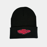 A black ribbed knit beanie featuring a centered, pink embroidered patch with stylized "Midnight Madness" text in a warped, circular graphic.