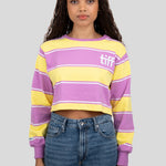 A model wears a long-sleeved cropped shirt featuring yellow, purple, and white stripes with the "TIFF" logo printed on the chest.