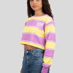 A model wears a long-sleeved cropped shirt featuring yellow, purple, and white stripes with the "TIFF" logo printed on the chest.