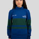 A model wears a blue and dark green quarter-zip pullover featuring "EST. 1976" and "TORONTO INTERNATIONAL FILM FESTIVAL" printed on the chest.