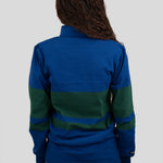 Back of model wearing a blue and dark green quarter-zip pullover.