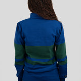 Back of model wearing a blue and dark green quarter-zip pullover.