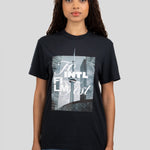 A woman modeling a black short-sleeve graphic t-shirt with a rectangular print of the New York City skyline featuring the text 'TO INTL FILM FEST'.