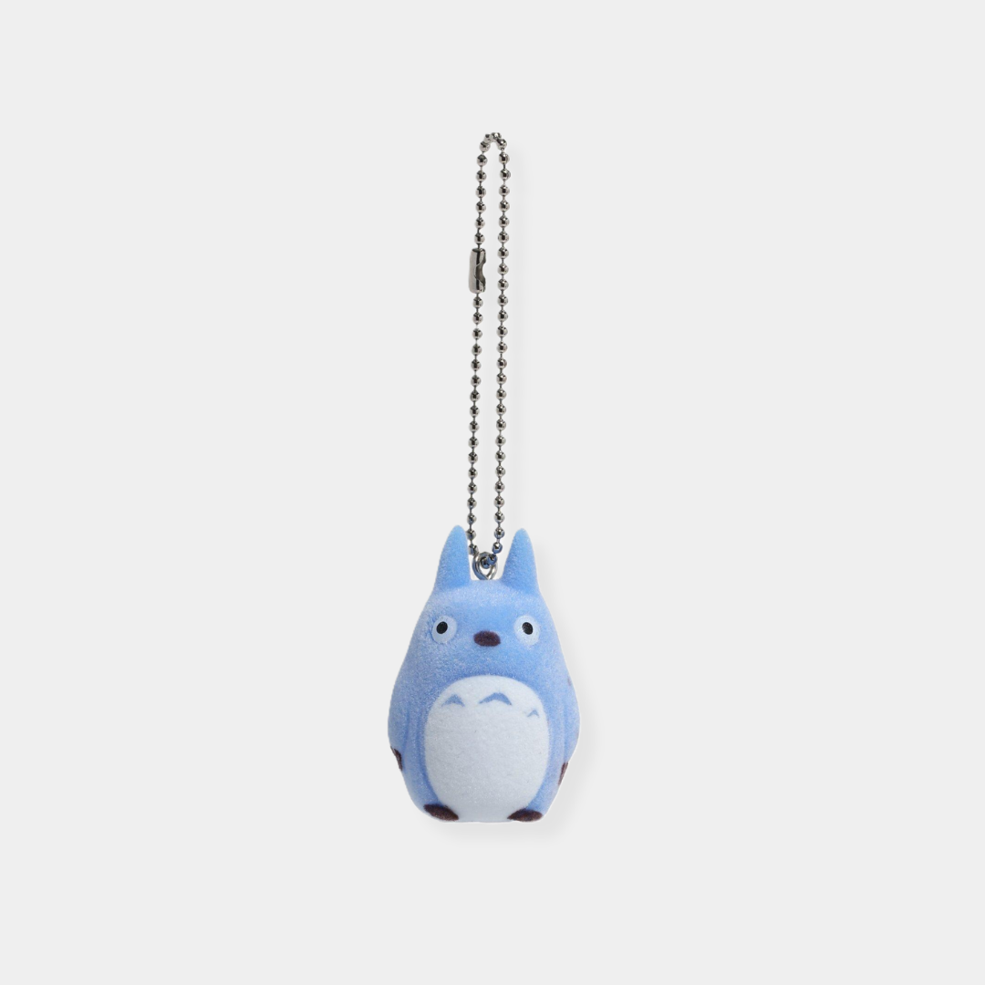 A light blue, flocked Totoro keychain with a white belly hanging from a silver ball chain.