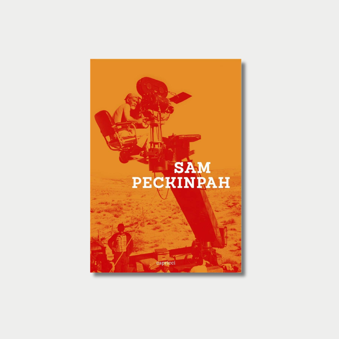 Book cover titled "SAM PECKINPAH" featuring a high-contrast orange and red photograph of a shirtless man operating a large film camera mounted on a crane over a desert landscape.