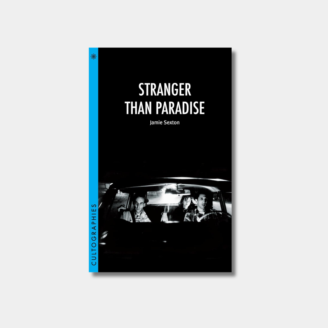 The book cover for "Stranger Than Paradise"features a black-and-white film still of three people in a car under a black background with a bright blue spine.

