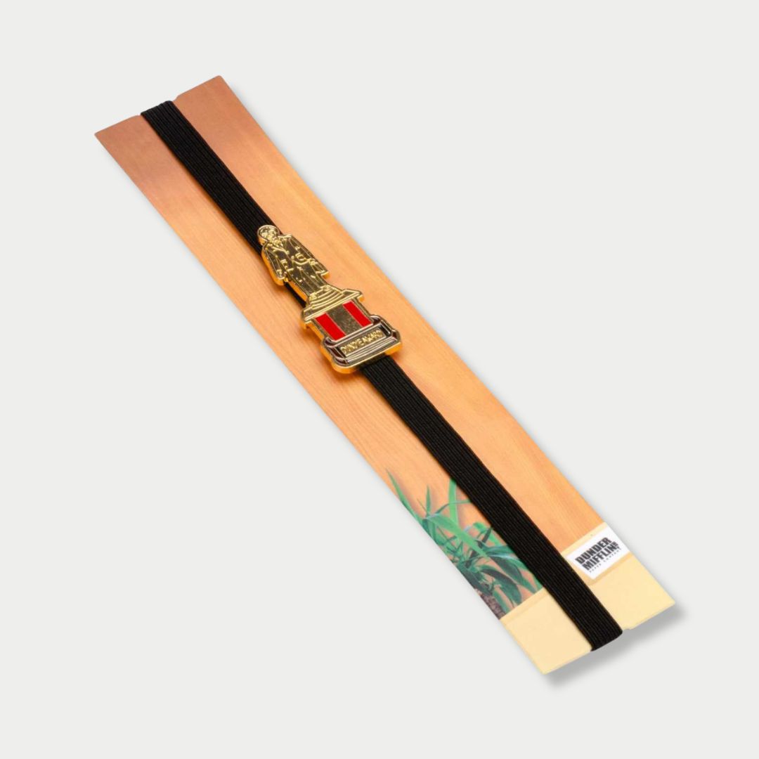 "The Office" elastic band bookmark packaged on a cardboard backing featuring a Dundie Award trophy enamel charm.
