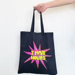 Navy tote bag with 'I love movies' design held by a hand on a white background