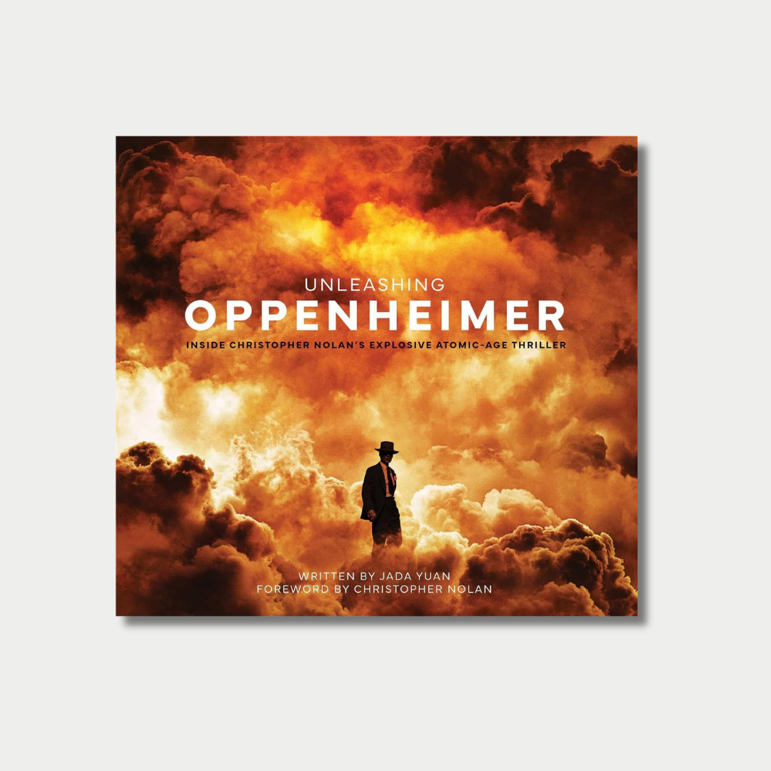 Book cover for "Unleashing Oppenheimer: Inside Christopher Nolan’s Explosive Atomic-Age Thriller" by Jada Yuan, featuring a silhouette of a man in a hat standing amidst a massive cloud of fiery orange and yellow smoke.