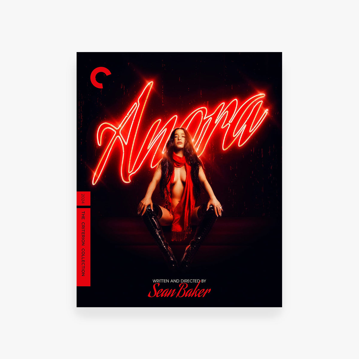 DVD cover for 'Anora' with a woman in a red outfit and neon text on a black background.