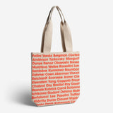 Beige tote bag with red text on a white background
