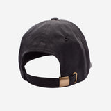 Back of black cap with a gold adjustable strap on a light gray background