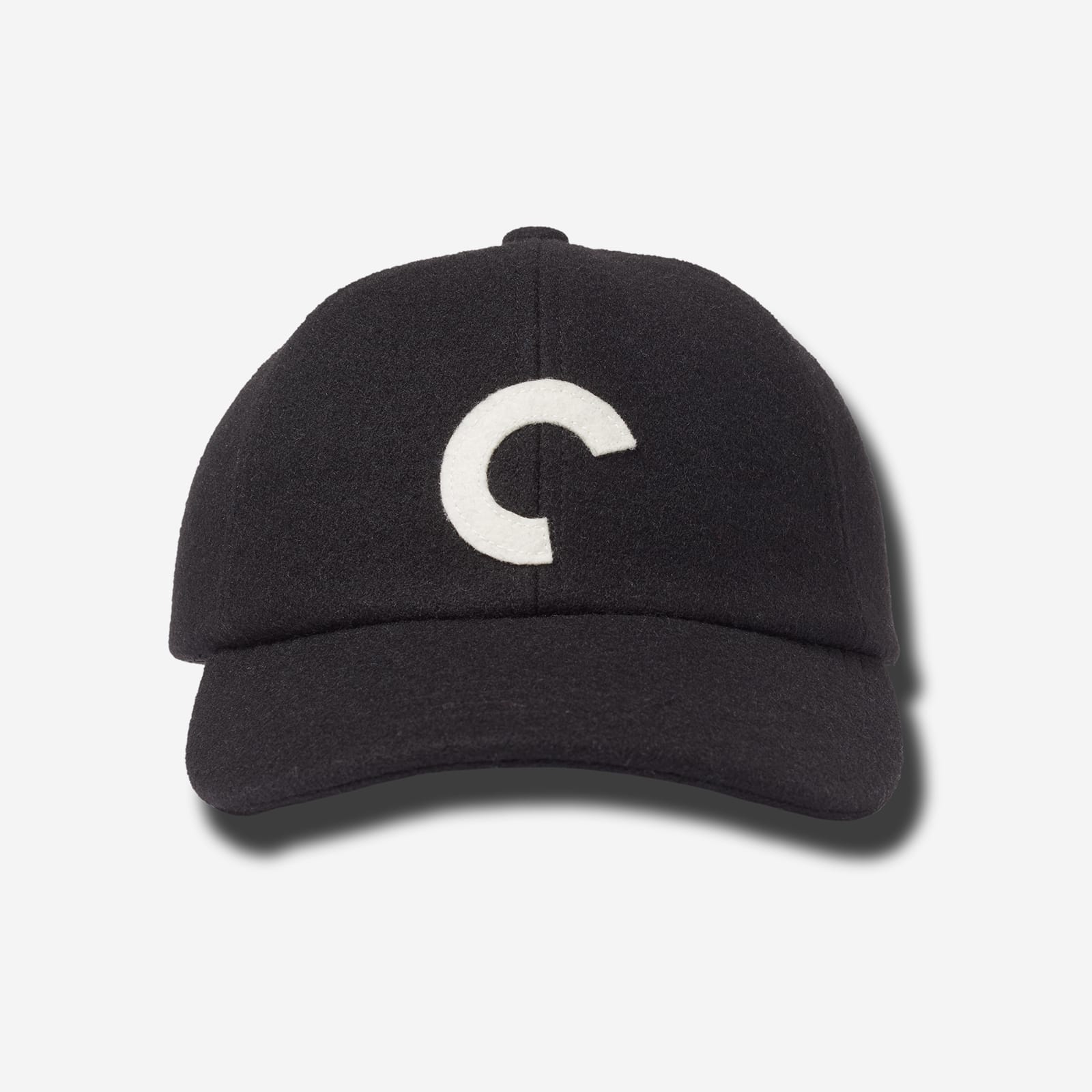 Black cap with a white logo on a light gray background