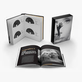 Open book with black and white images and text on a white background