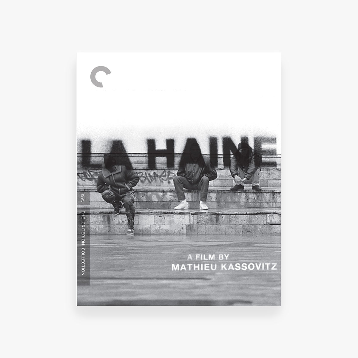 DVD cover of 'La Haine' with three people sitting on steps and the title in black text.