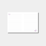 An open notebook shows lined white pages decorated with a small purple dragonfly in the top-left corner and a teacup in the bottom-right.