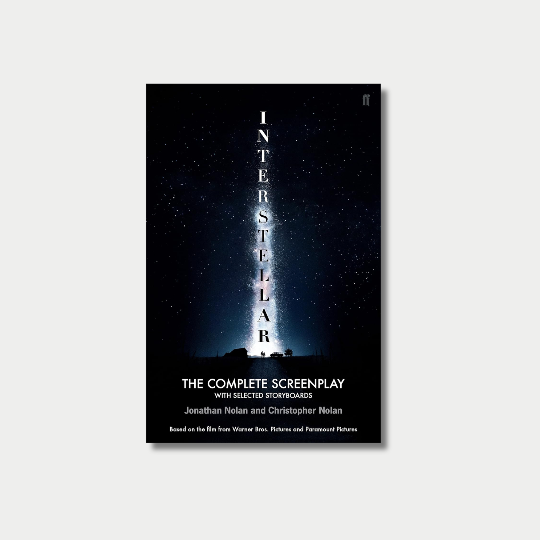 The book cover for "Interstellar: The Complete Screenplay" by Jonathan Nolan and Christopher Nolan features the title stacked vertically over a brilliant beam of starlight stretching into a vast, starry night sky above a silhouetted landscape, all centered against a light gray background.