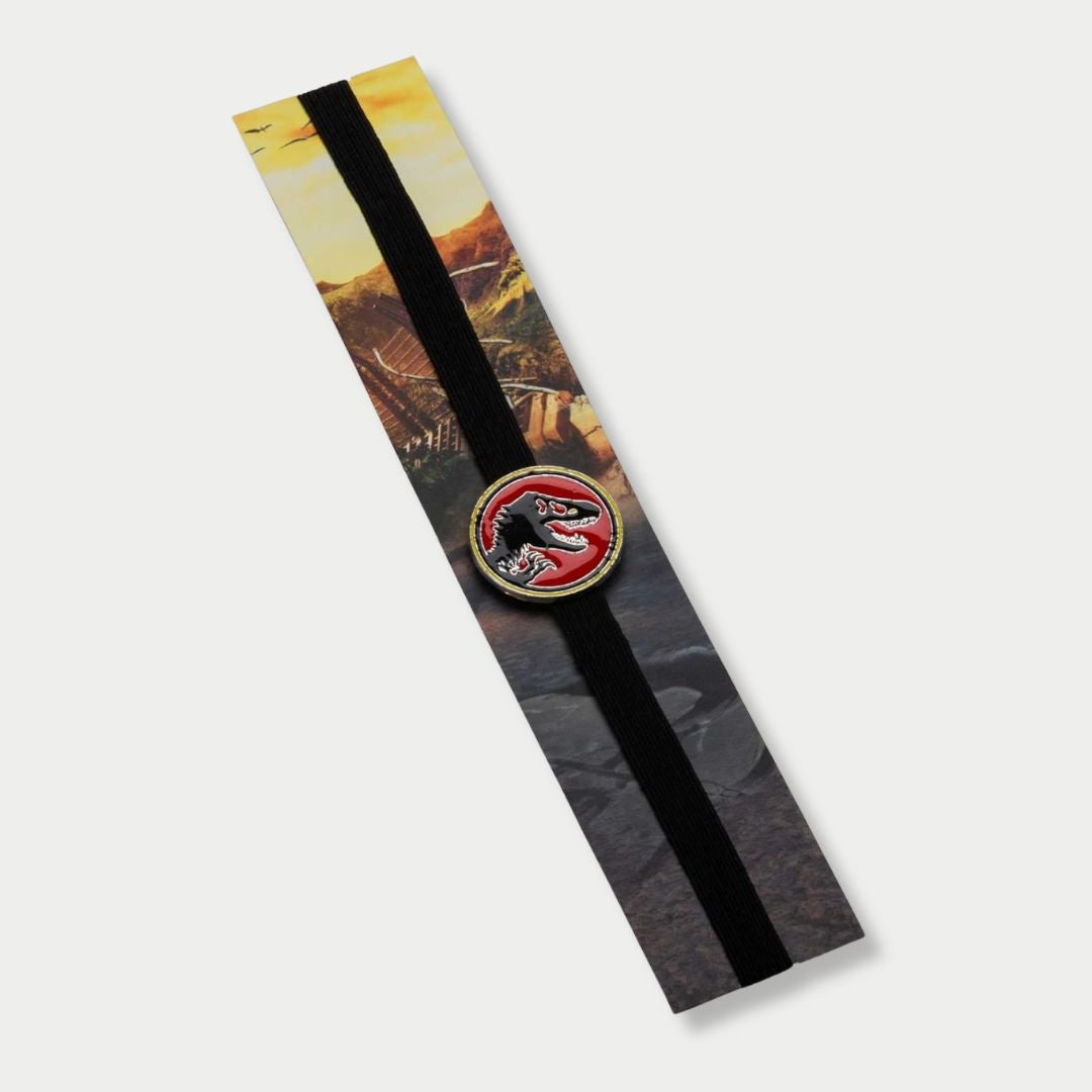 Jurassic Park elastic band bookmark packaged on a cardboard backing featuring a T-Rex red enamel charm.