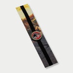 Jurassic Park elastic band bookmark packaged on a cardboard backing featuring a T-Rex red enamel charm.