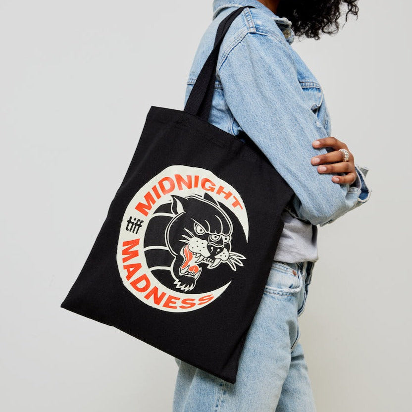 Woman carrying Midnight Madness TIFF tote over shoulder