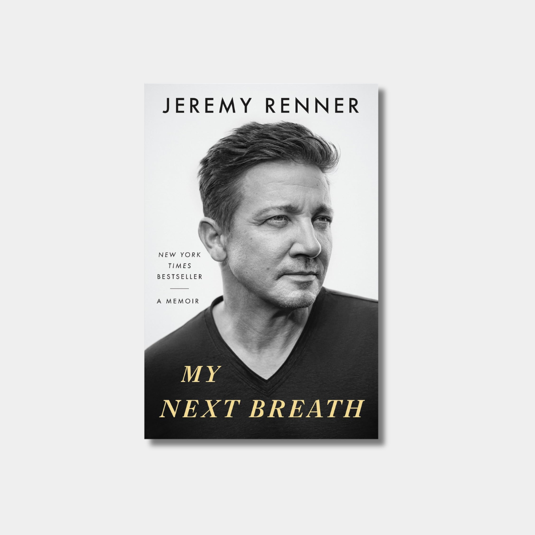 A book cover for Jeremy Renner's memoir titled "My Next Breath," featuring a black-and-white portrait of the actor against a plain white background with the title text in gold.