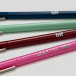 Four LePon tiff mechanical pencils in navy blue, mint green, burgundy, and pink, arranged diagonally on a light gray background.